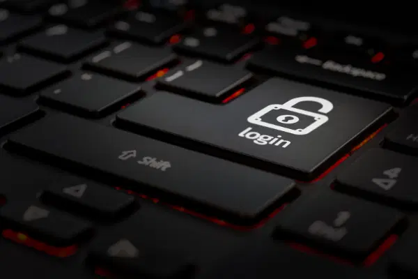 Black keyboard in red back-lighting, focusing on big button with lock icon and text 'login'.